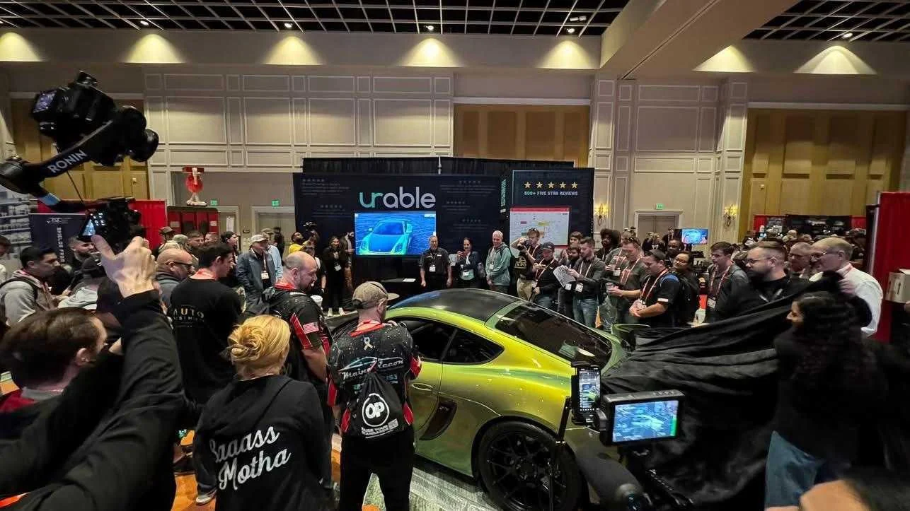 The cover coming off the Urable vehicle at the booth